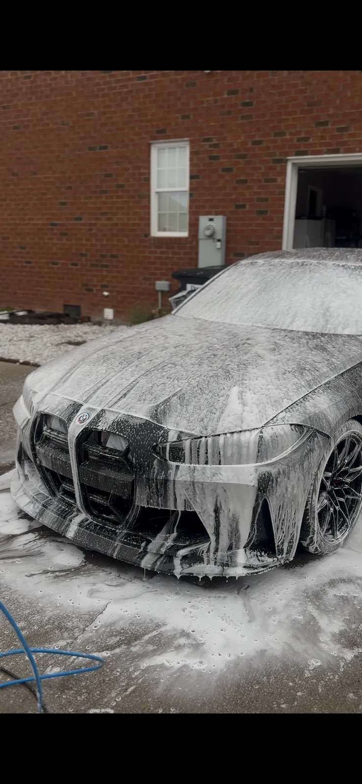 BMW covered in foam during an exterior wash
